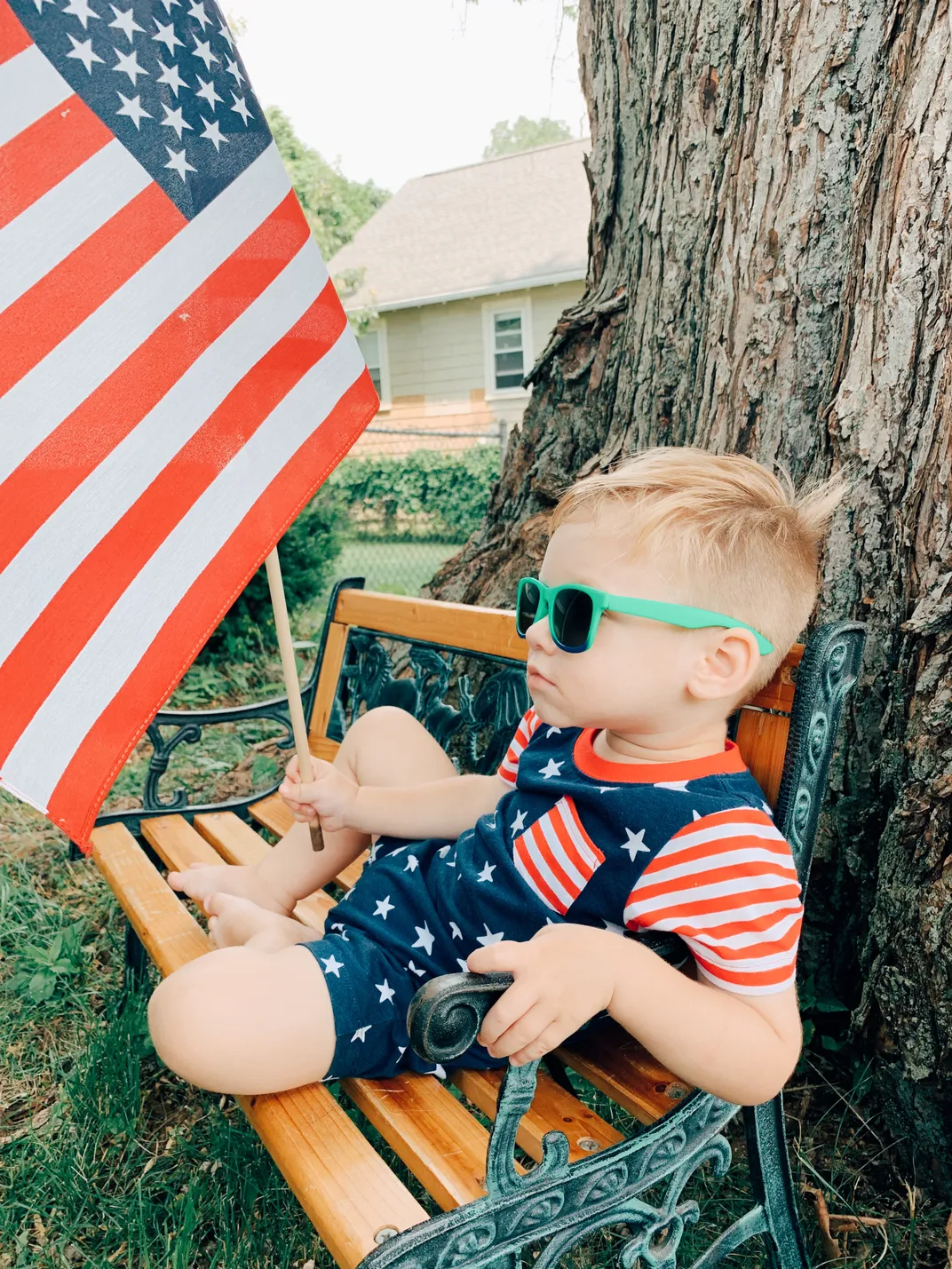 10 - On July 4, an aptly dressed toddler holds an American flag while sporting the perfect red, white and blue romper.