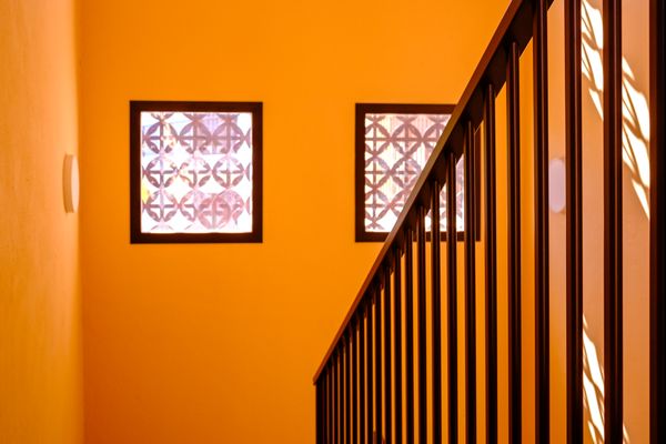 Two windows, railings and orange walls thumbnail