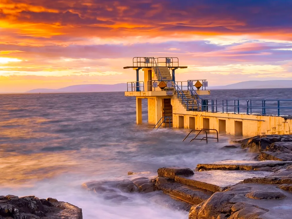 The photograph was taken during golden hour at the Blackrock Diving Tower on Salthill Promenade.
