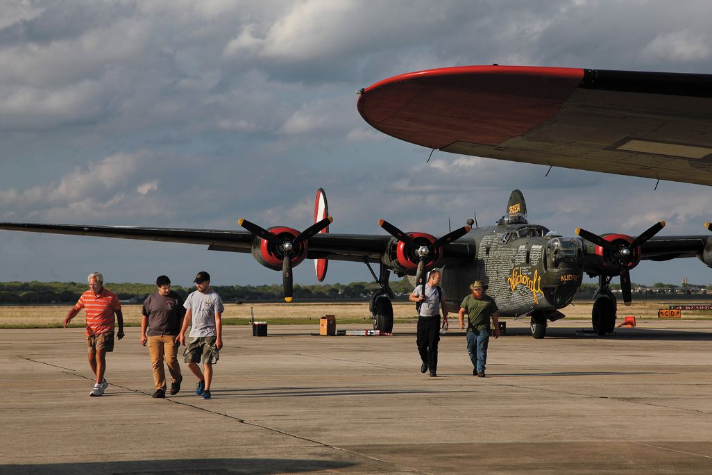 the roadies walk away from the last B-24J left flying
