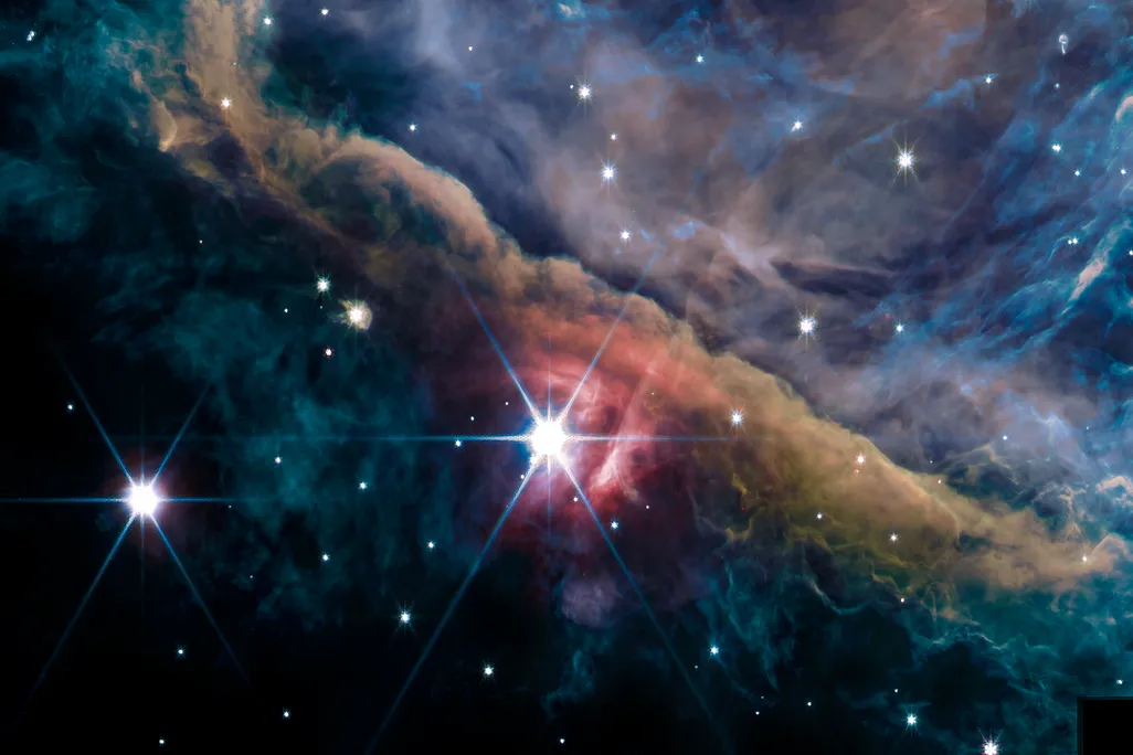 Stars and clouds of blue, purple and brown gas and dust