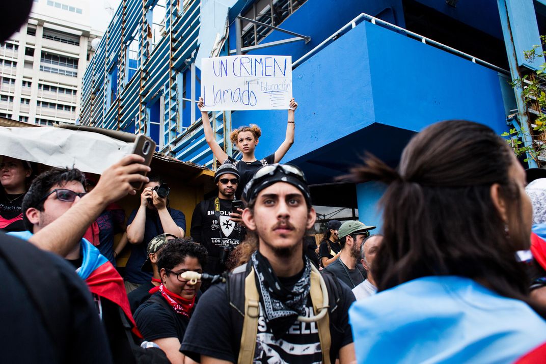 A woman holds a sign