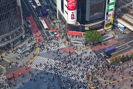 Crowds make their way through the Shibuya District in Tokyo, home to a key railway station and one of its busiest neighborhoods.