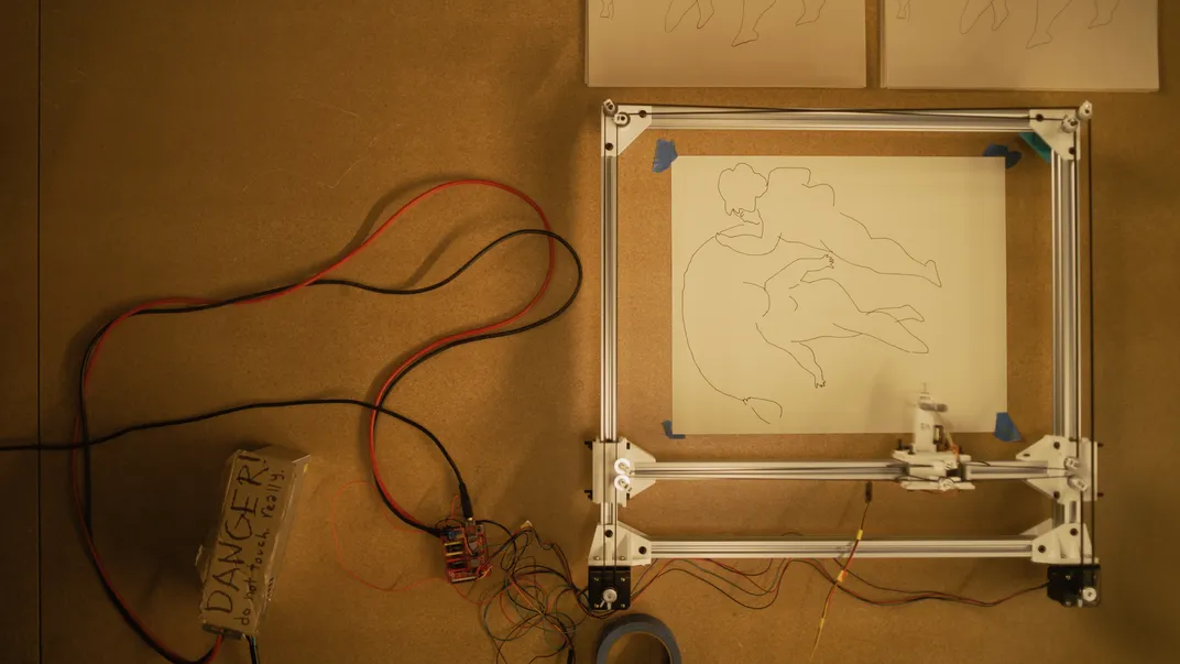 An aerial view of a print being drawn by a robotic arm