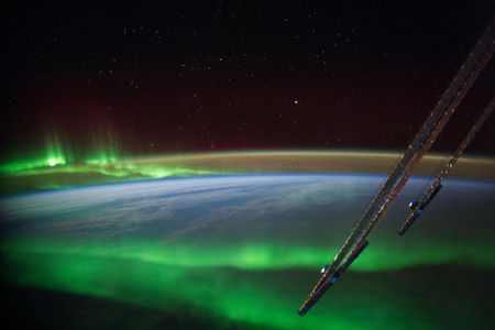 An aurora glows near Australia in a photo taken from the International Space Station. Auroras are products of charged particles from the sun interacting with Earth's magnetic field.