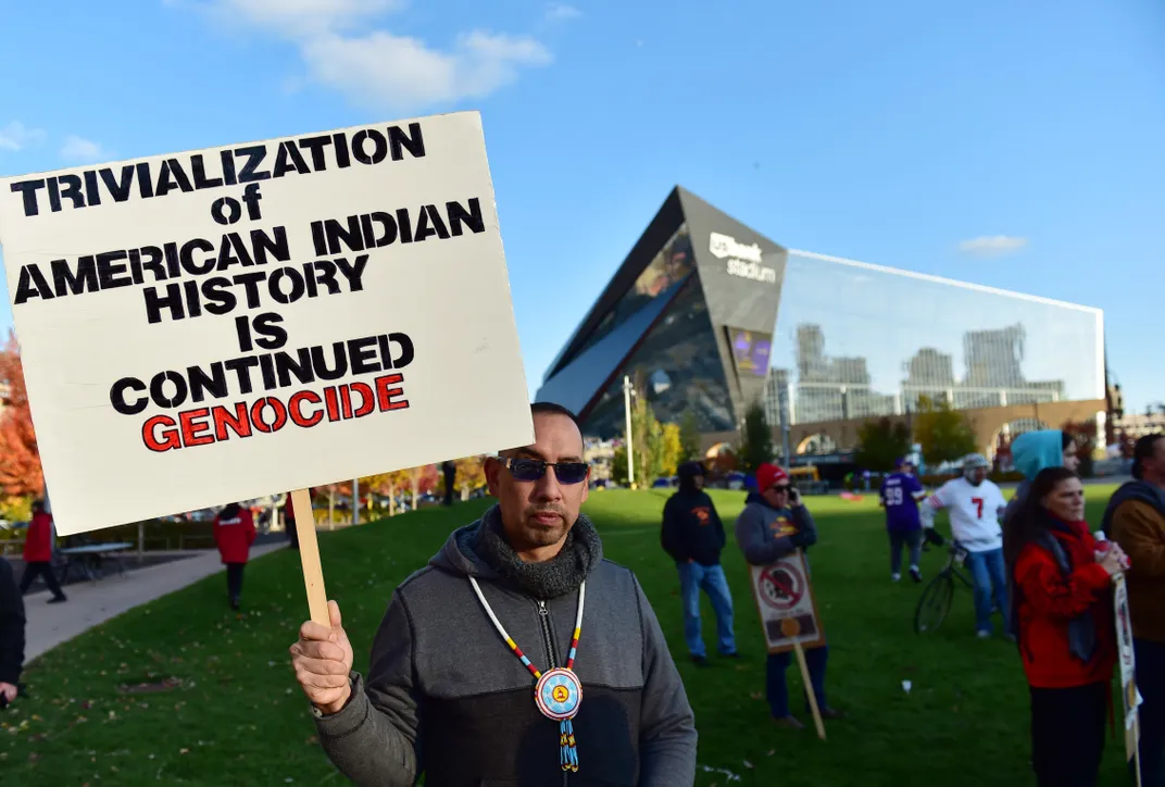 A protestor with sign outside U.S. Bank Stadium in Minneapolis in 2019