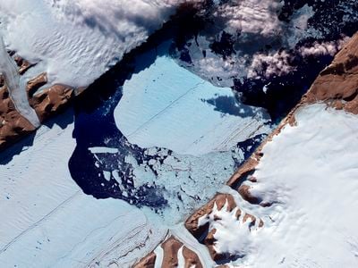 A massive ice island breaks free of the Petermann Glacier in northwestern Greenland in July 2012.