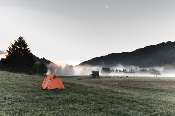 Camping solo in a misty sunrise in Bled, Slovenia. thumbnail