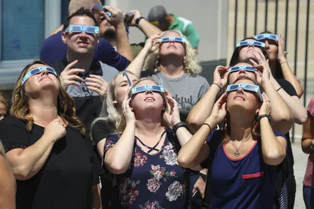 Texas Motor Speedway staff watch the August 21, 2017, solar eclipse in Fort Worth, Texas.