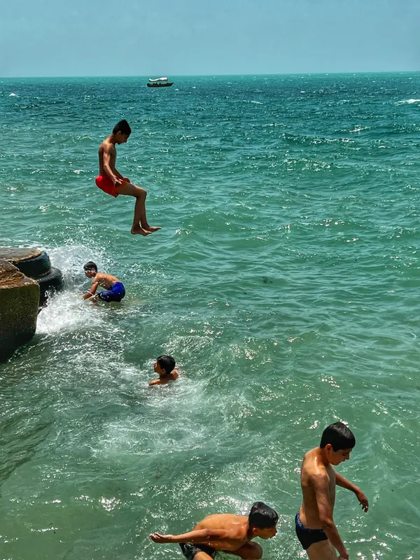 Children Swimming in the Southern Sea of Iran in Summer thumbnail