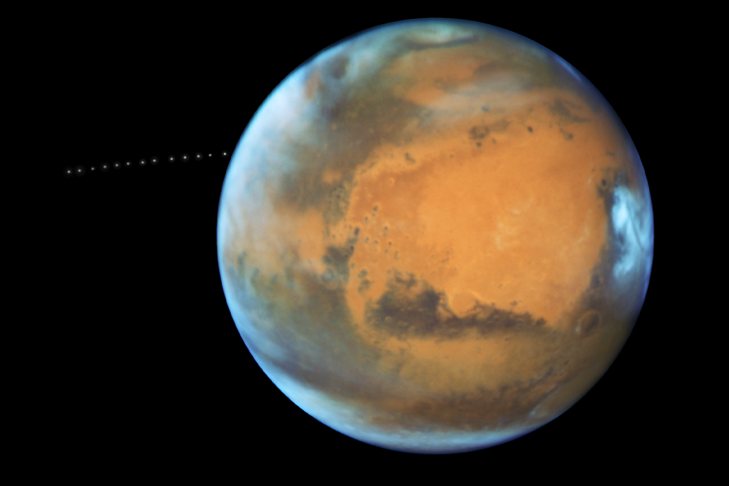 A photo of Mars with a time lapse of its moon Phobos orbiting it