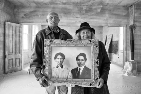 Elroy and Sophia Williams stand inside the Hopewell School, a site on the National Register of Historic Places. Once freed from slavery, Sophia&rsquo;s grandparents, depicted in the artwork she holds, acquired and then donated land for the school, one of nearly 5,000 built for African American children across from 1912 to 1937.