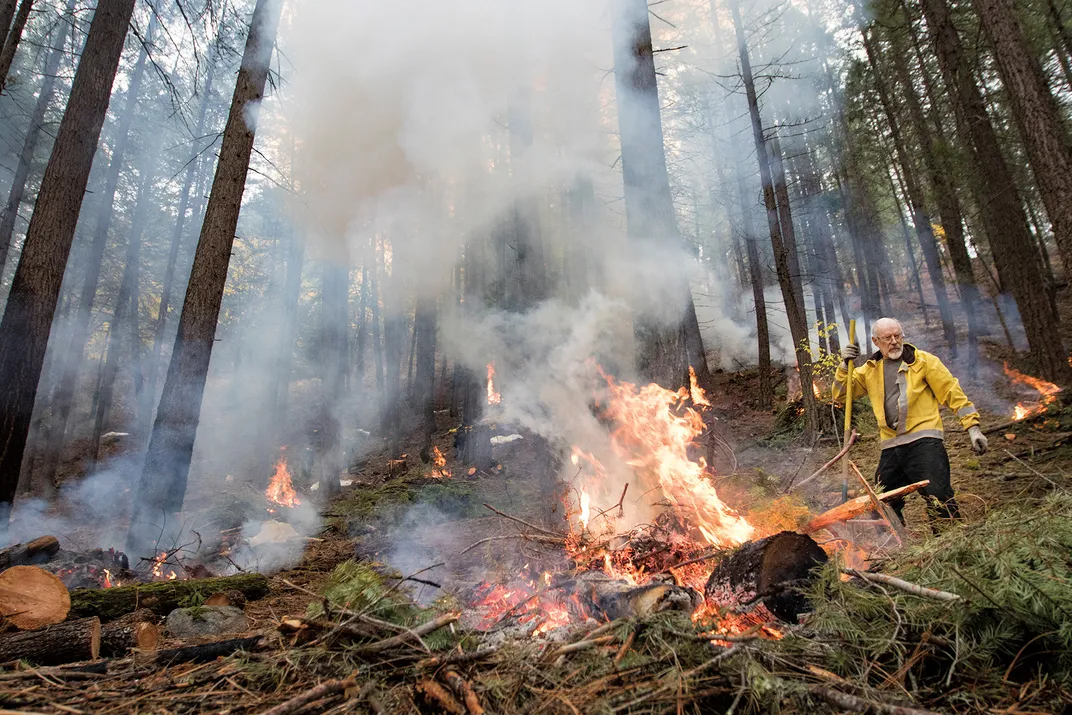 Attending to a pile burn in Plumas County, California, Greg Kinne, an artist, belongs to a cooperative that helps landowners wield fire on private property.