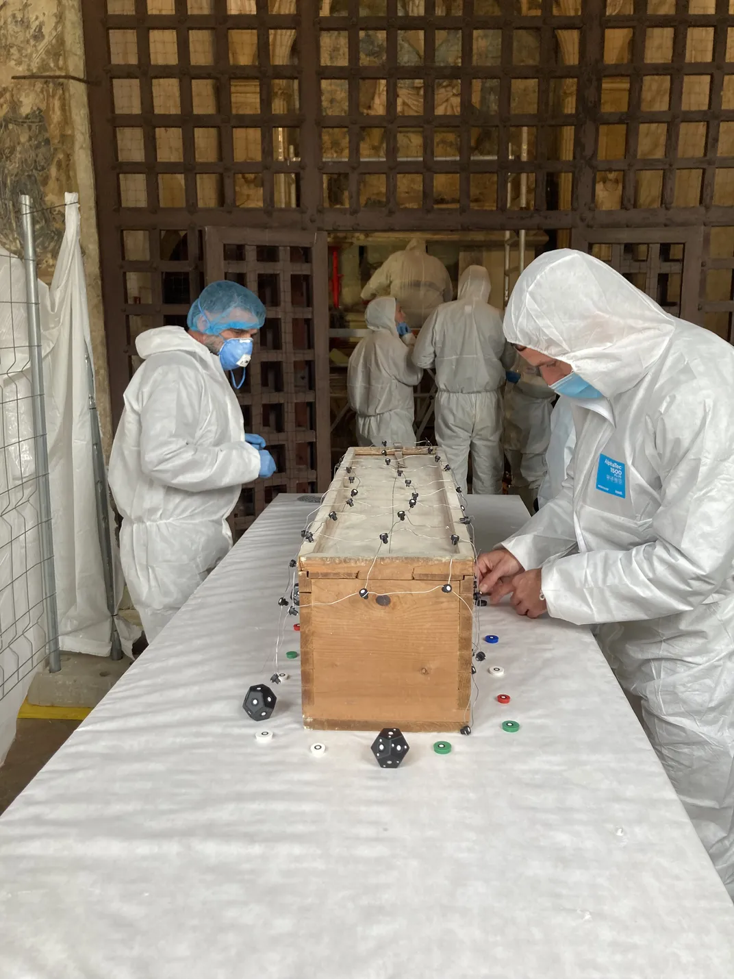 Researchers study the wooden box that holds Elisenda's remains.