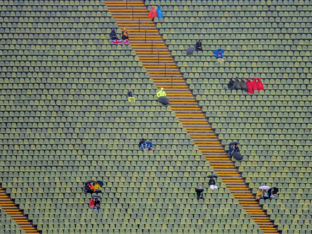 Constant rain, who cares? True sports fans are not impressed by it. Seen at the European Athletics Championships in Munich's Olympic Stadium.