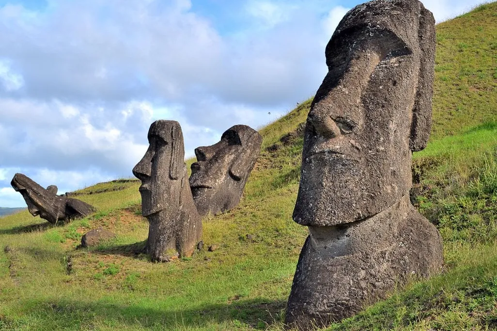 Large head-shaped statues on green island