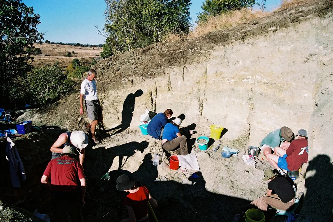 People excavating fossils from a clay pit