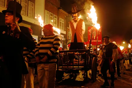 Participants in costume process with an effigy of Guy Fawkes, to be burned, as they take part in one of a series of processions during Bonfire night celebrations in Lewes, southern England.