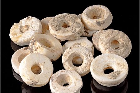 Researchers estimate the women were buried with more than 270,000 disc-shaped beads.