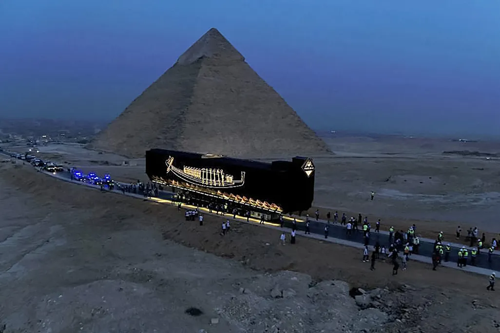 View of boat being moved past Pyramids of Giza