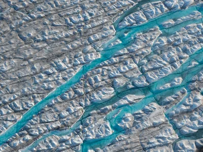 An aerial view of meltwater rivers carving into the Greenland ice sheet on August 04, 2019.