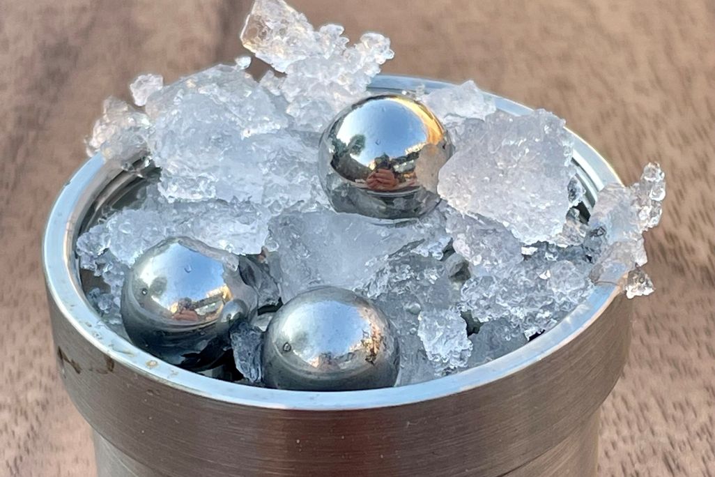 ice and balls in jar on wood table