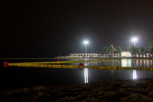 A night view of a seaside public park. thumbnail