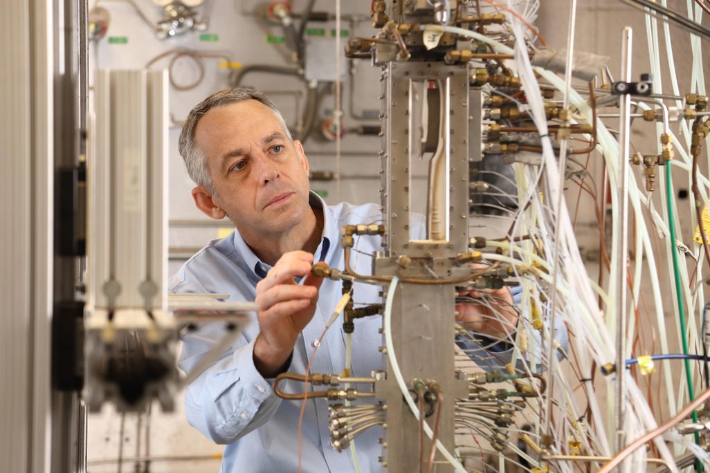 Chris Goyne looking at array of tubes and wires