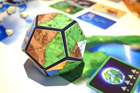 Participants use magnetic landscape tiles to build a perfect planet