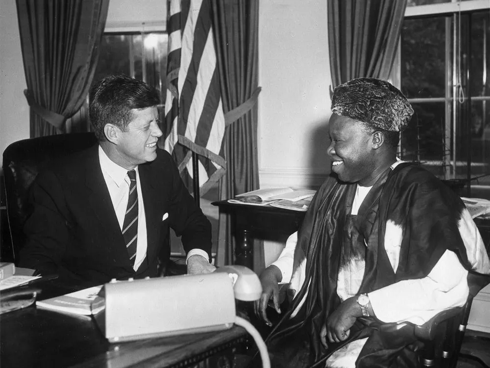 President John F. Kennedy meets with William H. Fitzjohn, charge d'affairs of Sierra Leone, in the Oval Office on April 27, 1961.