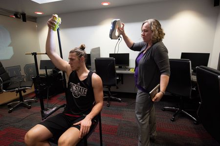 Wyatt Walker poses for a 3-D scan of the sculpture's missing right arm