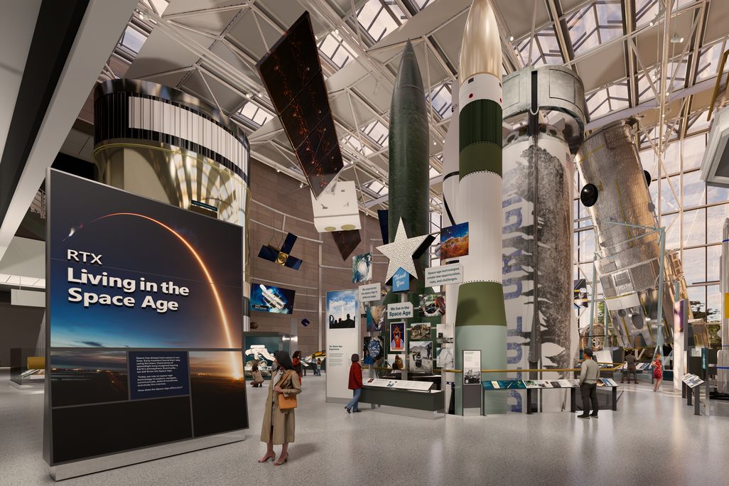 a view of a museum exhibit with a large rocket booster at the center