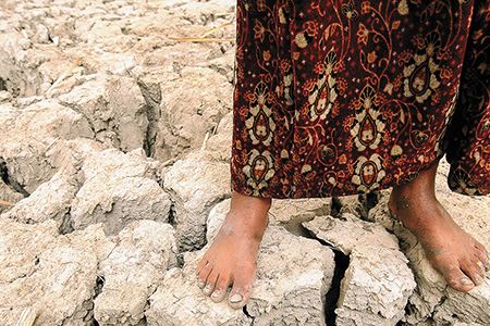 An Iraqi girl stands on former marshland, drained in the 1990s because of politically motivated water policies.