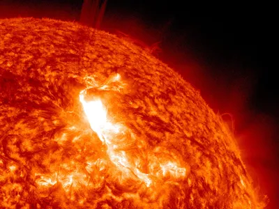 A solar flare erupting from the sun in deep space.