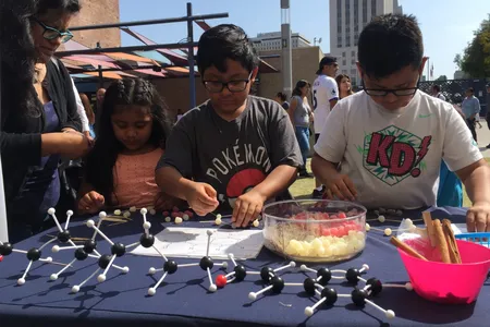 Children participate in a hands-on science activity with the Smithsonian Latino Center for a Dia del Niño festival hosted by LA Plaza de Cultura y Arte in Los Angeles, California. (Smithsonian Latino Center)
