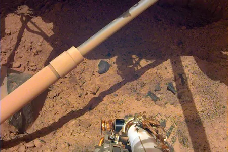 NASA&#39;s InSight lander peers down at the Martian surface. The mission recorded more than 1,300 quakes during its four years of operation.