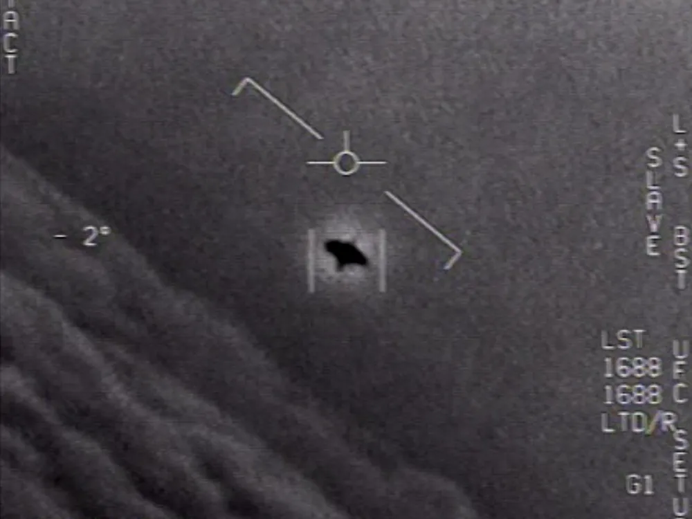 A black, unidentified object in the sky captured by a U.S. Navy jet.