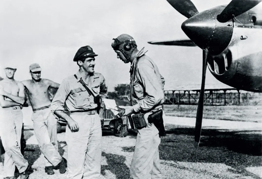 McGuire talks to Charles Lindbergh on an air field