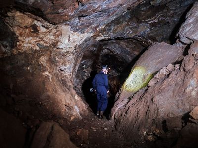 Paleontologist Lee Berger, who led the new research, walks in the Rising Star cave system in South Africa, where the possible burial sites were uncovered.