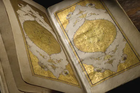 The manuscript features an array of gilded designs and illustrations.