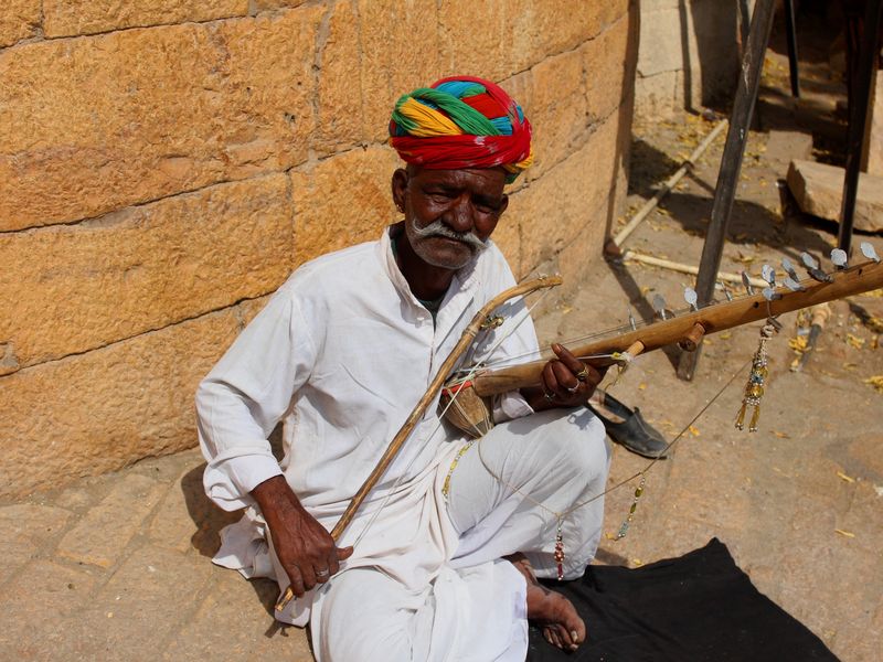 A musician playing traditional string instrument in Jaipur, Rajasthan