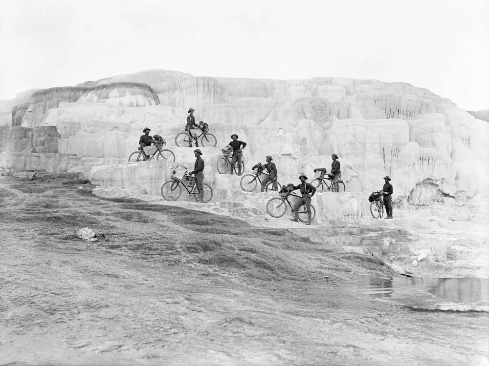 Members of the 25th Infantry Bicycle Corps pose on Minerva Terrace at Mammoth Hot Springs in Yellowstone National Park in 1896