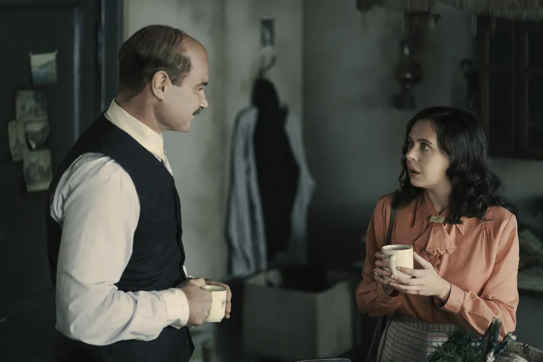 Liev Schreiber as Otto Frank (left) and Bel Powley as Miep Gies (right)