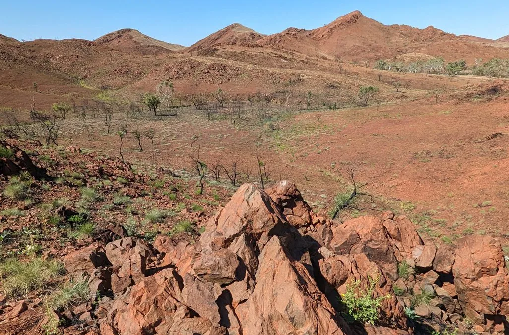 Brown dry landscape with cones of broken rock in the foreground