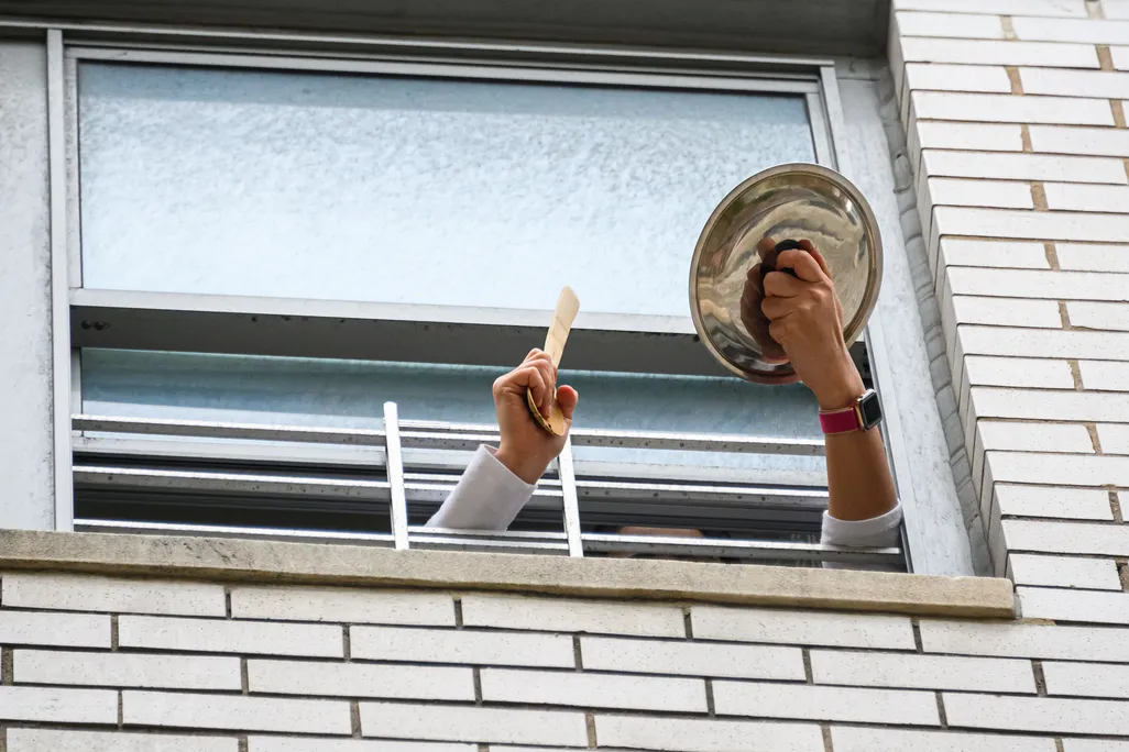 Person applauds from window
