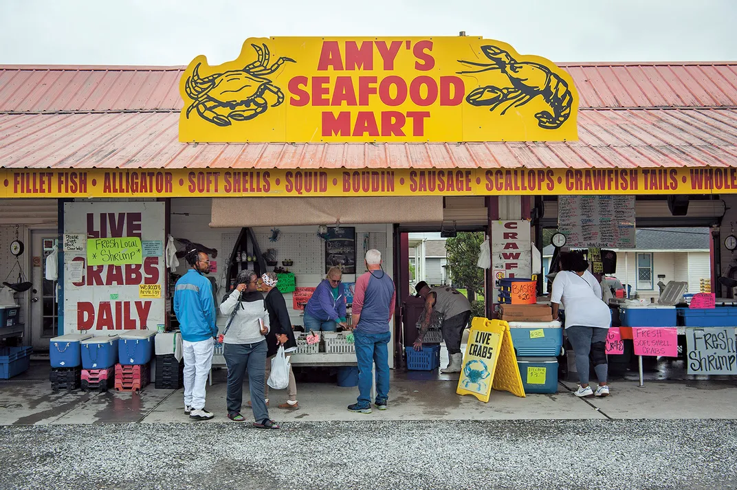 people in line for lunch at a fish market