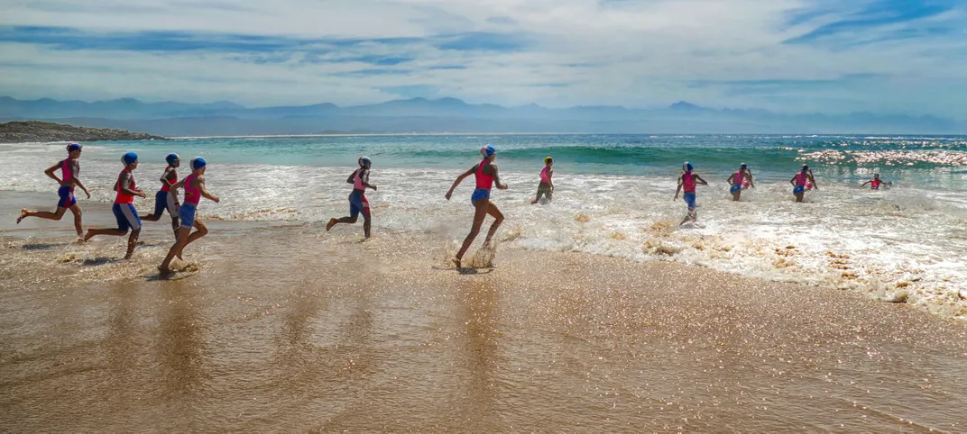3 - Young people train to become lifeguards on the shores of a beautiful beach.