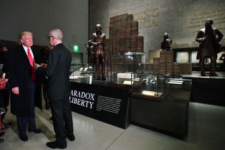 President Trump talks to Smithsonian Secretary David Skorton in front of the "Paradox of Liberty" exhibit.