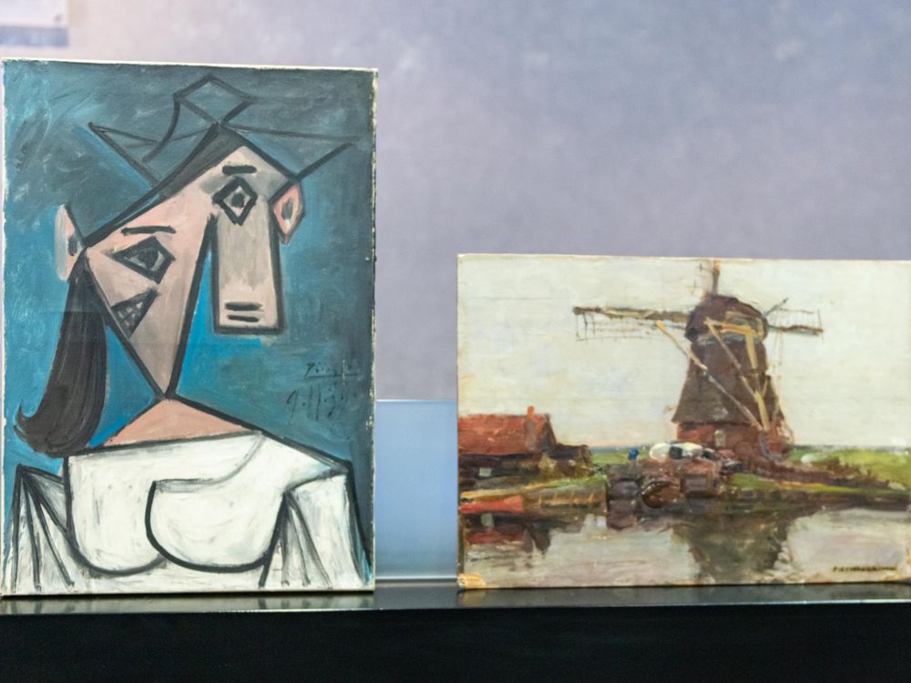 The Cubist bust portrait sits vertically next to the short horizontal Mondrian canvas, a gray- and green-toned depiction of a windmill over a body of water