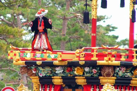 A marionette performs atop a Matsuri float